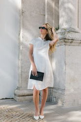 a lady in a white Qipao dress